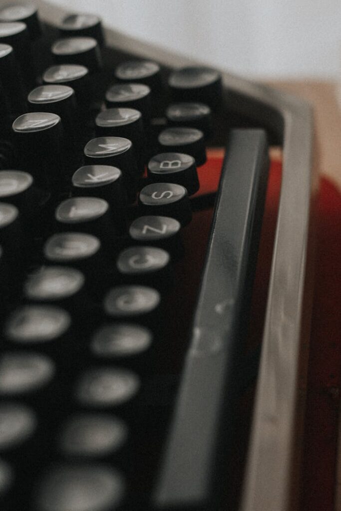 Closeup of obsolete retro typewriter with white letters on black buttons for publishing document